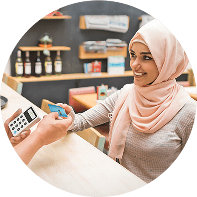 person handing card to cashier